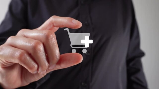 Close-up of a woman's hands holding an animated shopping cart icon with the "add" button between her two fingers. Add more products to your cart.