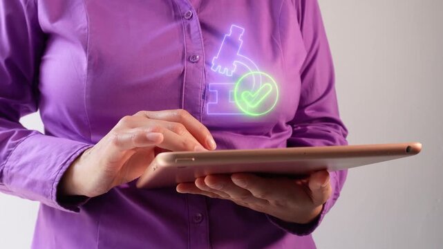 Laboratory results. A businesswoman interacting with her tablet, which displays a virtual microscope icon and a checkmark.