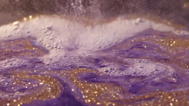 Mesmerizing close-up of a sparkling purple bath bomb dissolving in water, creating vibrant swirling clouds of gold and violet glitter, representing luxury, relaxation, and self-care indulgence.