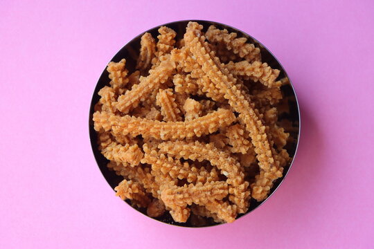 Chakli, Murukku, Traditional Indian Diwali snack in a dish, crispy spiral shaped deep fried savoury snack made with rice flour and spices