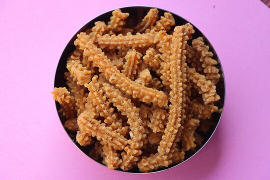 Chakli, Murukku, Traditional Indian Diwali snack in a dish, crispy spiral shaped deep fried savoury snack made with rice flour and spices