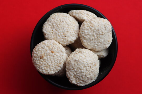 Revadi (also spelled Revdi or Rewari) is a popular, crunchy Indian sweet candy made primarily from sesame seeds (til) and jaggery (gud) or sugar. It is a traditional winter staple in North India