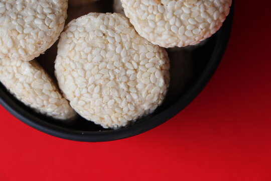 Revadi (also spelled Revdi or Rewari) is a popular, crunchy Indian sweet candy made primarily from sesame seeds (til) and jaggery (gud) or sugar. It is a traditional winter staple in North India
