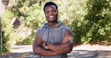Fototapeta premium Portrait, fitness and black man in street, arms crossed and happiness with exercise. Outdoor, runner and African person with nature, wellness and commitment to training routine and health benefits