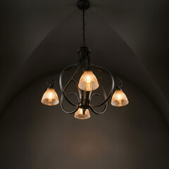 Elegant black metal chandelier with four warm light bulbs