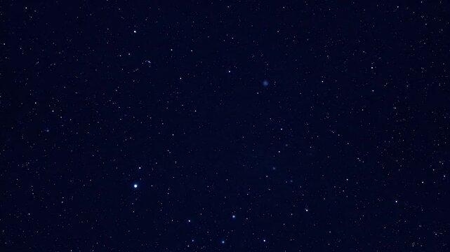 A dark navy sky is filled with countless bright, twinkling stars and faint distant galaxies