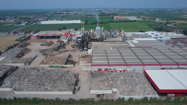 drone view of an integrated cement manufacturing plant showing rotary kiln line, preheater tower, clinker cooling system, raw material storage yards and heavy industrial processing infrastructure.