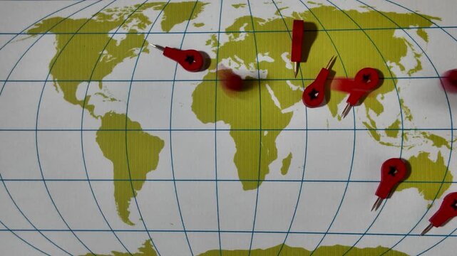 red wooden pin flags fall on random marking locations on green continents global map, travel points, or strategic planning