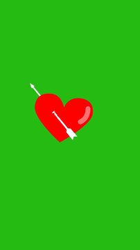 cupid arrow attack red heart on green background. vertical footage isolated solid color