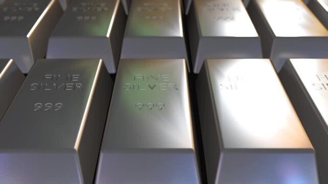A 3d animation of silver bullion bars, each bar is stamped with the text "FINE SILVER" and the purity mark "999", indicating they are 99.9% pure silver.