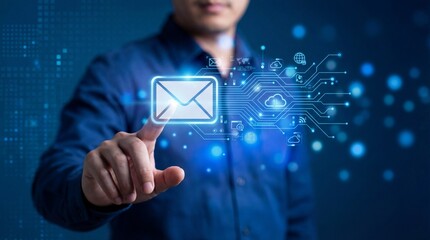 Close up of a persons finger touching a glowing digital envelope icon surrounded by a network of technology symbols