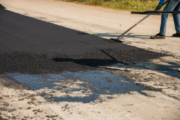 Infrastructure development asphalt paving process documentation at construction sites