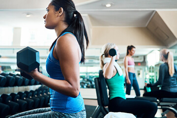 Fototapeta premium Fitness, weight training or woman in gym with dumbbell, power or bicep curl in bodybuilding. Commitment, challenge or athlete with equipment, intense workout or strength in muscle transformation.
