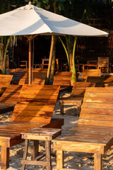 Fototapeta premium Empty tropical beach loungers at seaside resort in Vong island, Vietnam