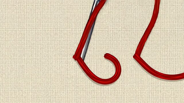 Red thread passes through the eye of a silver sewing needle