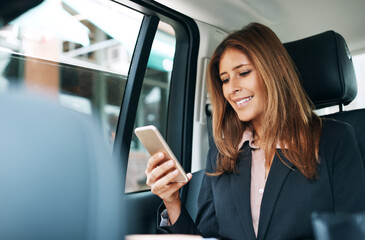 Phone, taxi and typing with business woman in car for ehailing service, private chauffeur and contact. Commute, transport navigation app and communication with person and mobile in vehicle for trip © BuyoutReese07/peopleimages.com