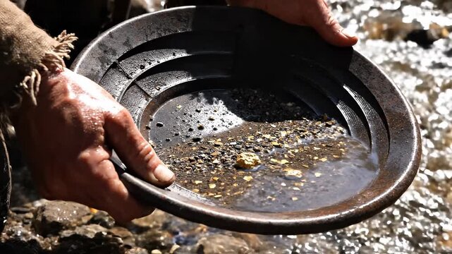 Gold prospector pans for gold in a shallow river. Hands sift through sediment, revealing a shiny nugget. Focus on the raw discovery process.
