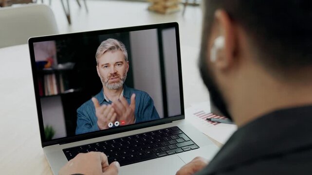 Senior life coach motivates to Indian student on video call laptop screen view. Trainer explains importance of self knowing for personal growth via laptop while clients listens