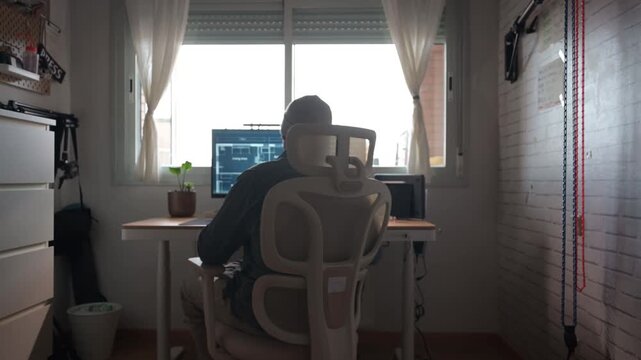 Architect multitasking at home office using computer and smartphone