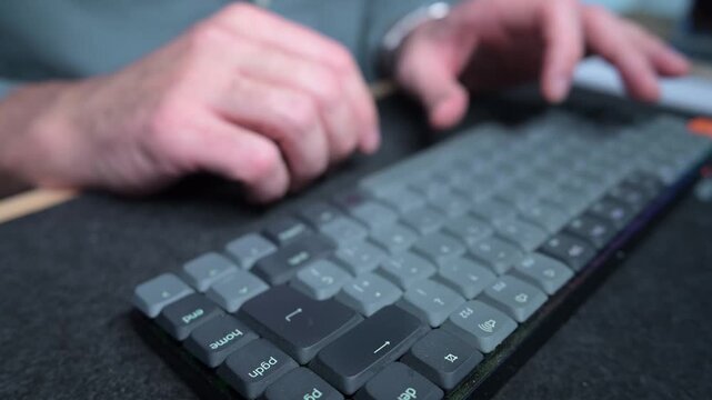 Man typing fast on a modern custom mechanical keyboard