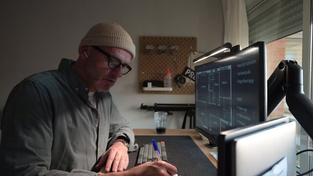 Tired architect taking a break while working on a blueprint