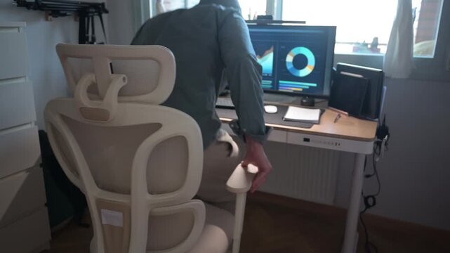 Mature man working from home office using an adjustable height standing desk