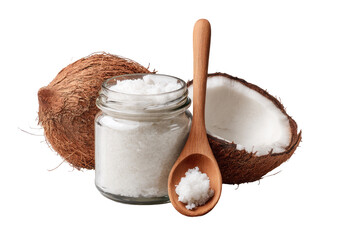 Fresh coconut flakes in a glass jar, with a wooden spoon and half coconuts