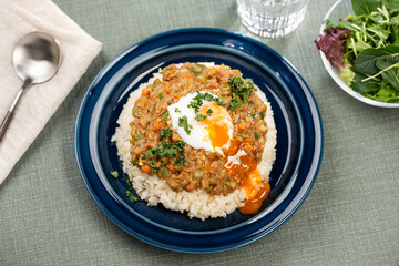 家庭の食卓で楽しむ半熟卵をのせたキーマカレー