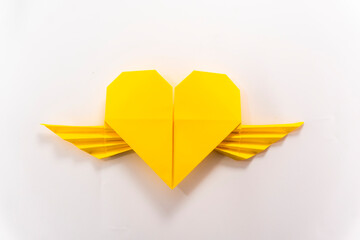 origami heart with wings on white background.
