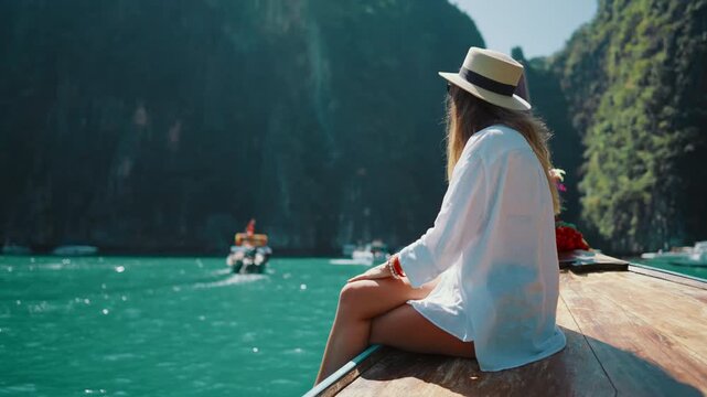 Famous Maya bay in Thailand, pleasure boats floating near islands, lady admiring . Popular tourist location, inspiration by unique landscape and seaview, summer holidays in Asia, explore new countries