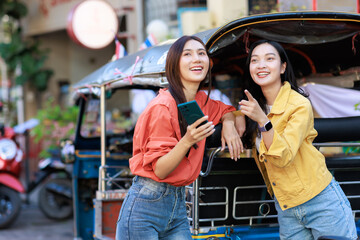 Fototapeta premium Young asian women traveling, exploring city street