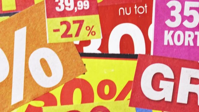 Pan across promo discount stickers and prices on colorful retail flyers