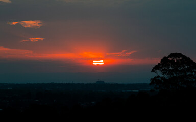 Obraz premium Beautiful view of red sun during summer sunset.