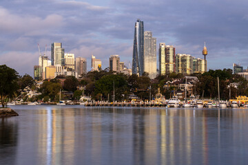 Sydney, Australia: Dramatic nightfall over the Sydney bay and the affluent Balmain residential district with the CBD skyline in the background.