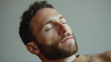 Fototapeta premium Close-up portrait of a man's face. he appears to be in his late twenties or early thirties, with dark hair and a beard.