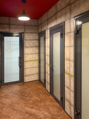Fototapeta premium A hallway with a door on the left and two doors on the right