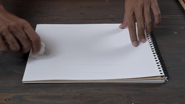 A hand cuts blank paper using a small cutter, creating a crisp, dry slice sound with soft scratch as the blade moves through paper