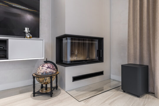 Modern minimalist corner fireplace with vintage globe bar