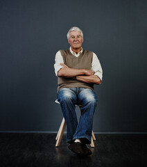 Portrait, old man and relax in studio with arms crossed, positive attitude or good mood for...