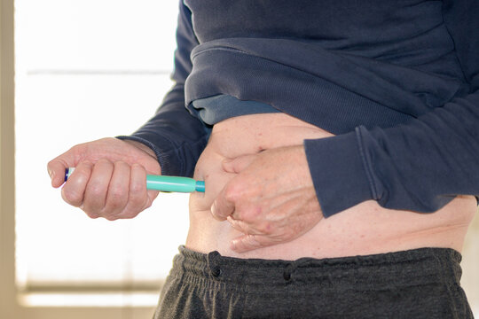 Man Performing Self Injection Abdomen