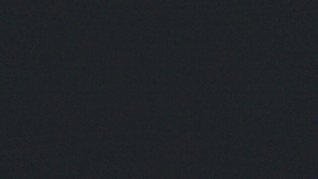 Bioluminescence of the ocean wave as seen underwater. Night underwater view of the breaking ocean wave shining strong blue light caused by bioluminescence. High level of noise