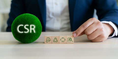CSR (Corporate Social Responsibility) corporate sustainability concept. A hand points to CSR blocks...