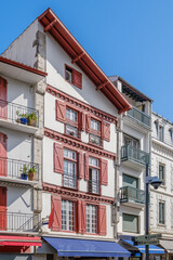 Naklejka premium Traditional Basque Facade with Red Shutters in Saint Jean de Luz