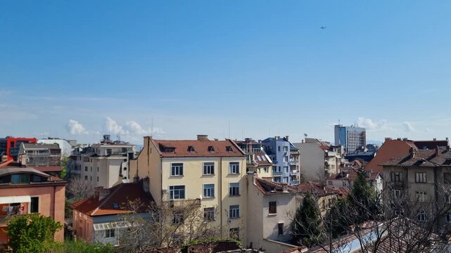 Panoramic footage of a backyard in Sofia, Serdika district, showing residential buildings and local daily life under a bright spring sky in Bulgaria