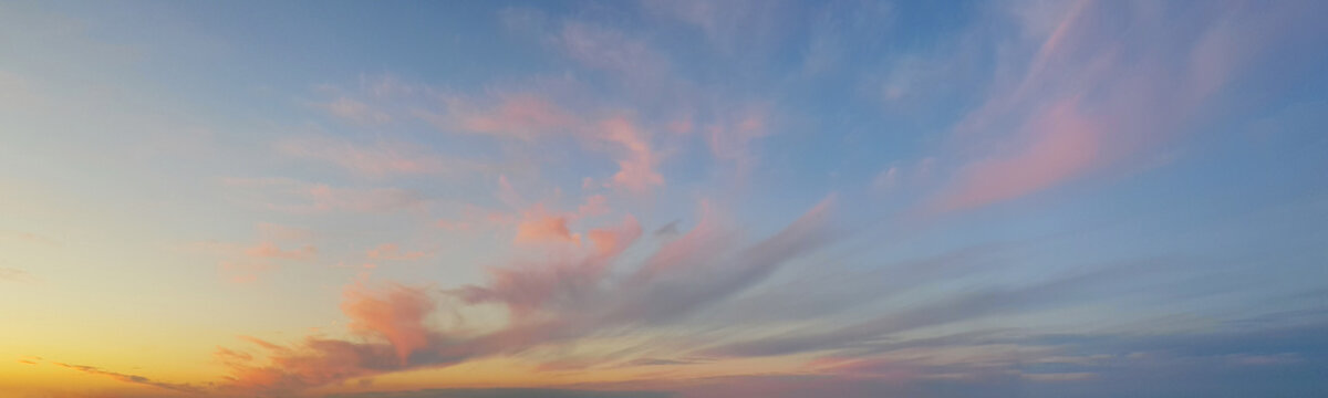 Panoramic landscape with sunset sky, sun and gold