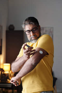 Man using insulin patch at home for diabetes management