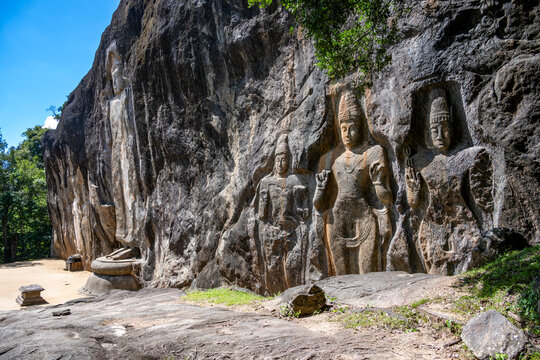 Ancient Buddha statues carved into rock at Budurudawagala temple Sri Lanka