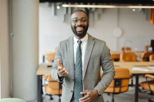 Confident businessman smiling in modern office workspace