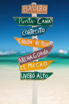 Colorful Beach Signpost In Caribbean island With Arrows Pointing To Bavaro, Punta Cana, Arena Gorda, El Macao, Ubero Alto, Cortecito beach Destinations in Dominican Republic