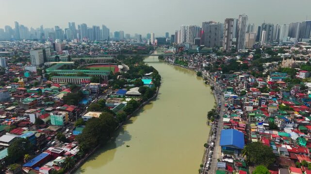Muddy Pasig River flowing through colorful urban homes in Taguig, Metro Manila